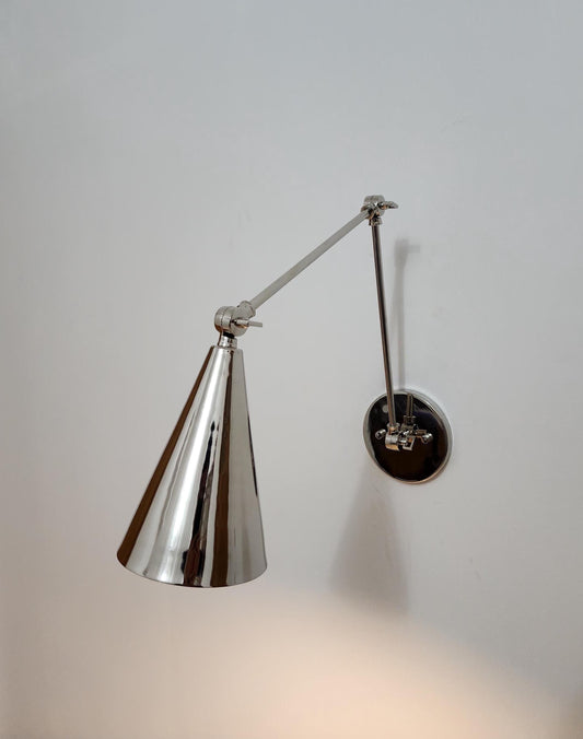 Adjustable single-light brass and chrome wall sconce. Ember Lighting