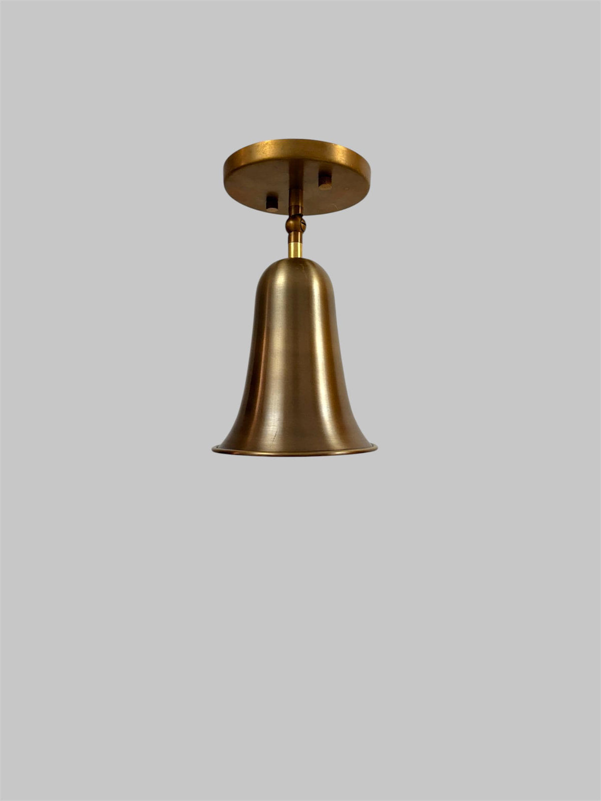 Brass bell cone bedside wall light Ember Lighting