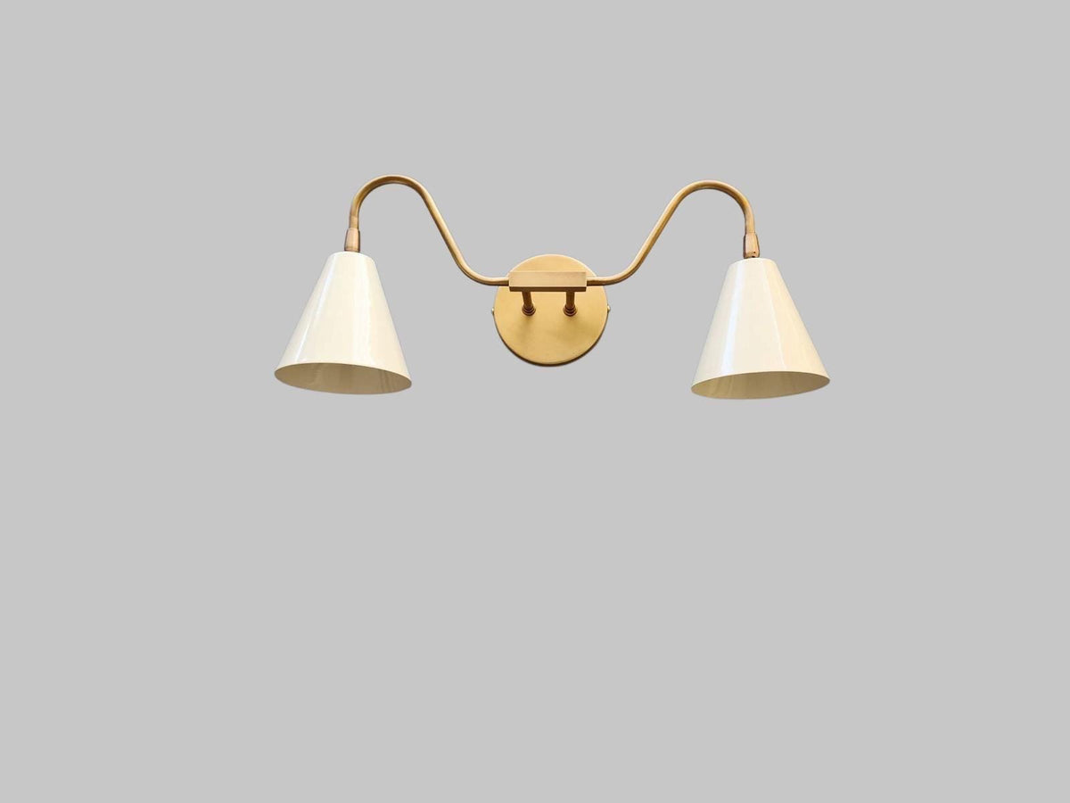 Double arm wall sconce in modern brass design. Ember Lighting