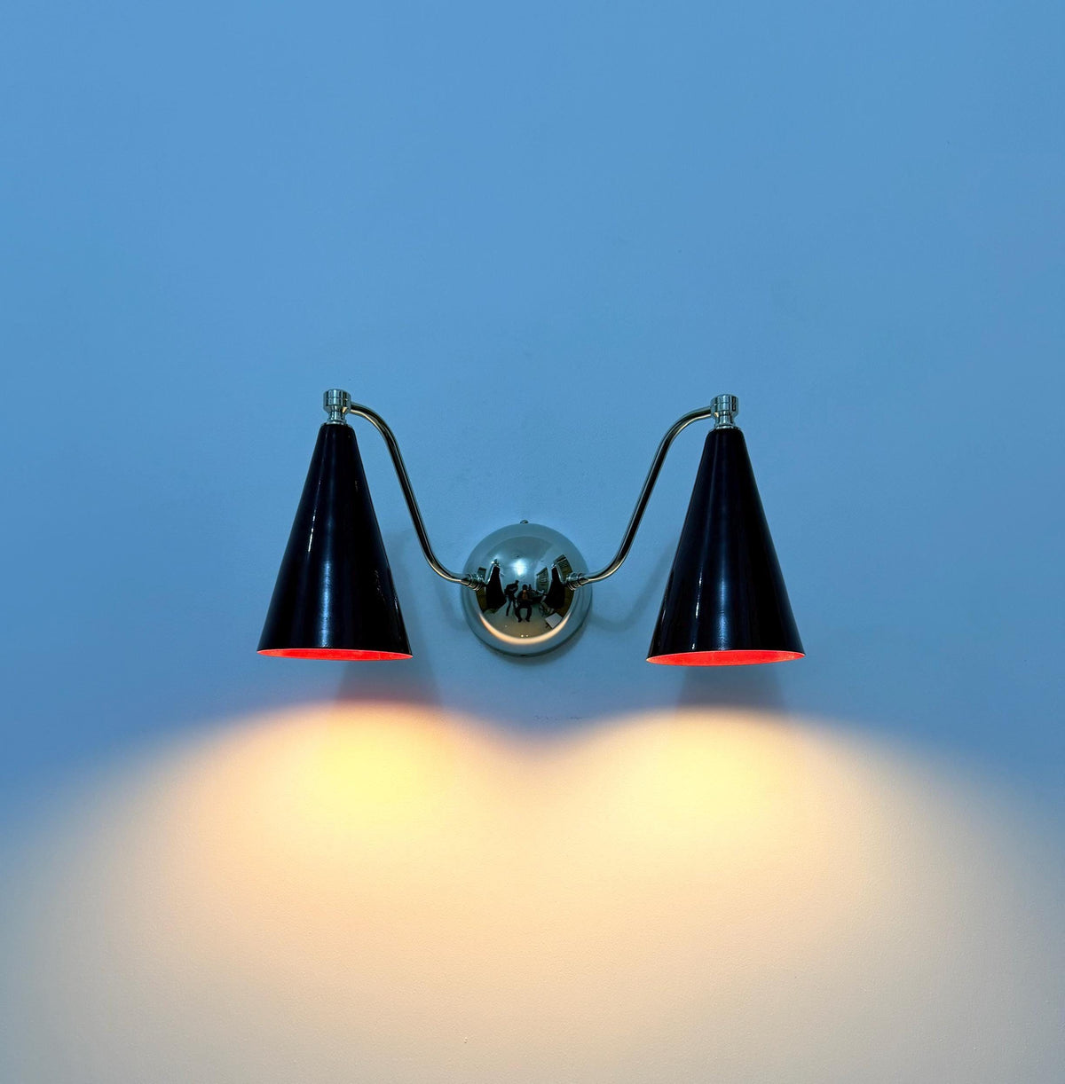 Double cone brass sconce featuring elegant wine shades. Ember Lighting