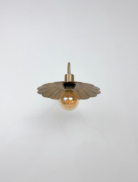 Handcrafted brass wall sconce with scalloped shade. Ember Lighting