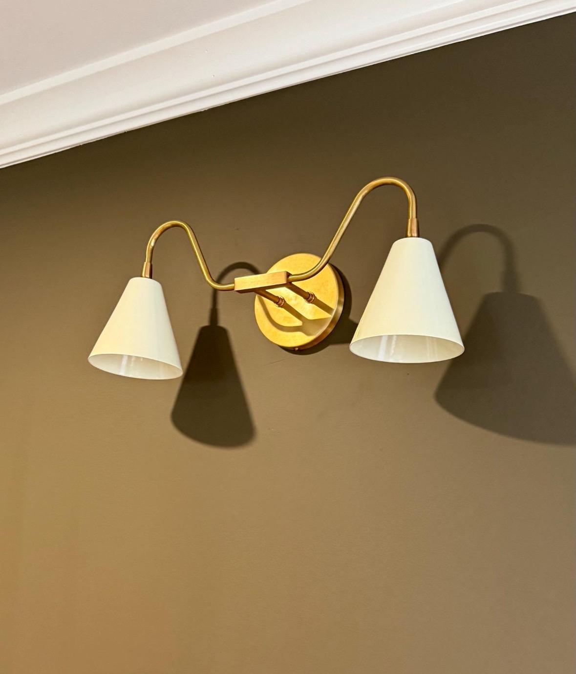 Handmade brass double arm sconce in mid-century style. Ember Lighting