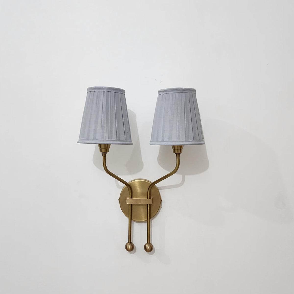 Vintage pleated double shade brass wall light.