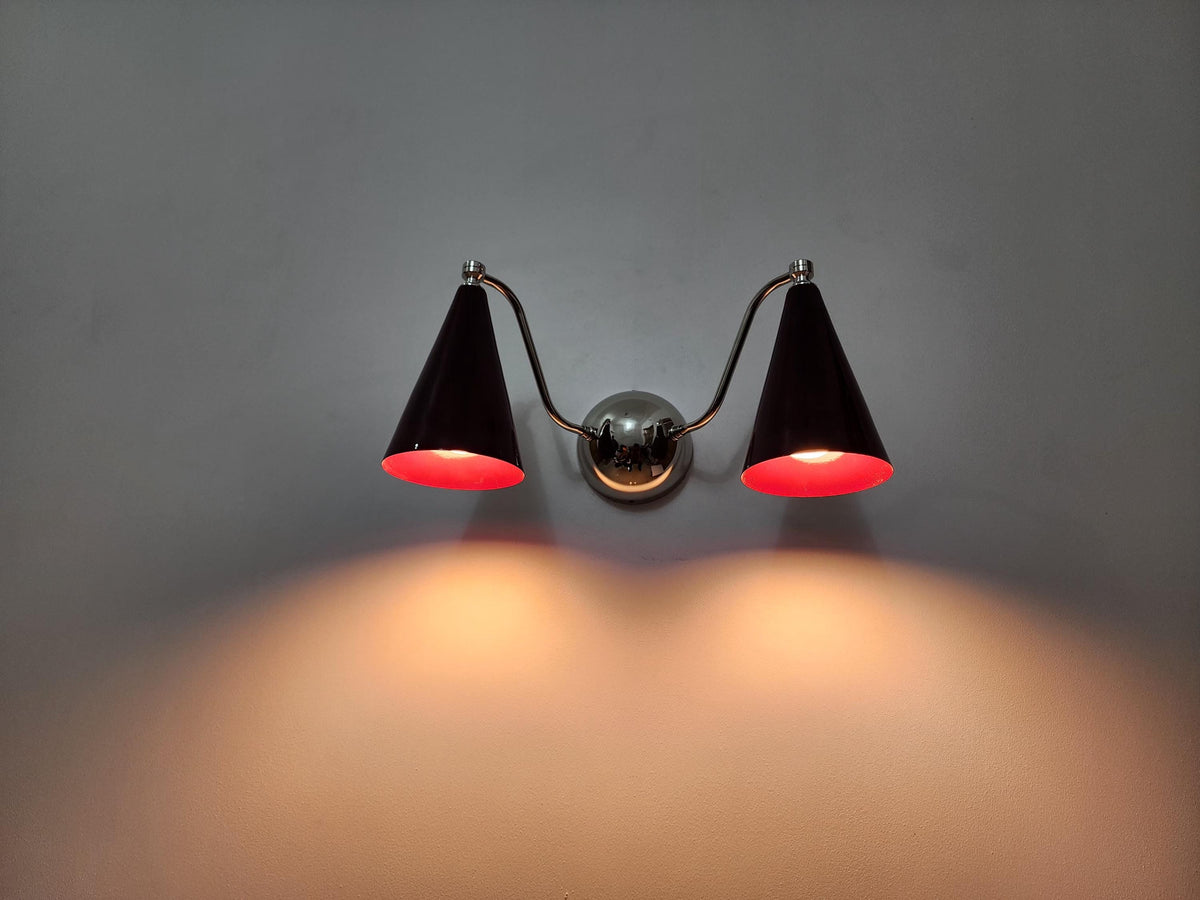 Mid-century double cone brass sconce featuring wine shades. Ember Lighting