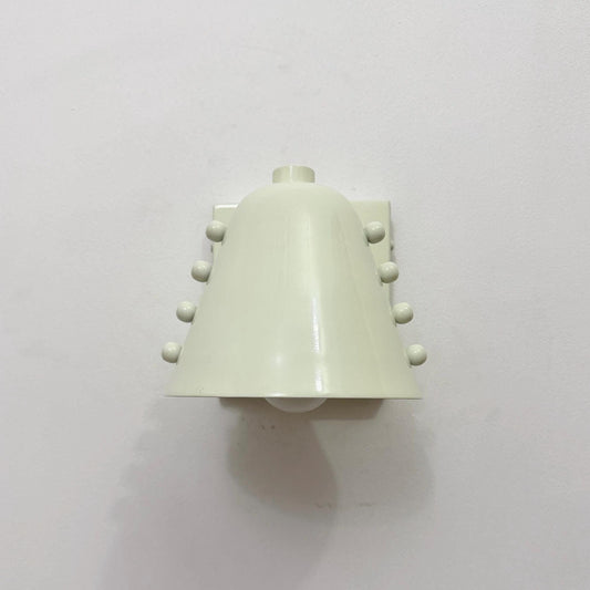 Minimal brass wall light fixture with a sleek white cone shade. Ember Lighting