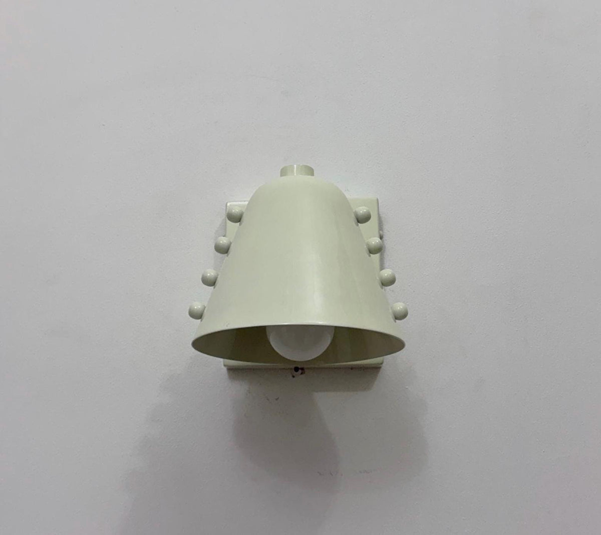 Minimalist wall light fixture in brass with sleek design. Ember Lighting