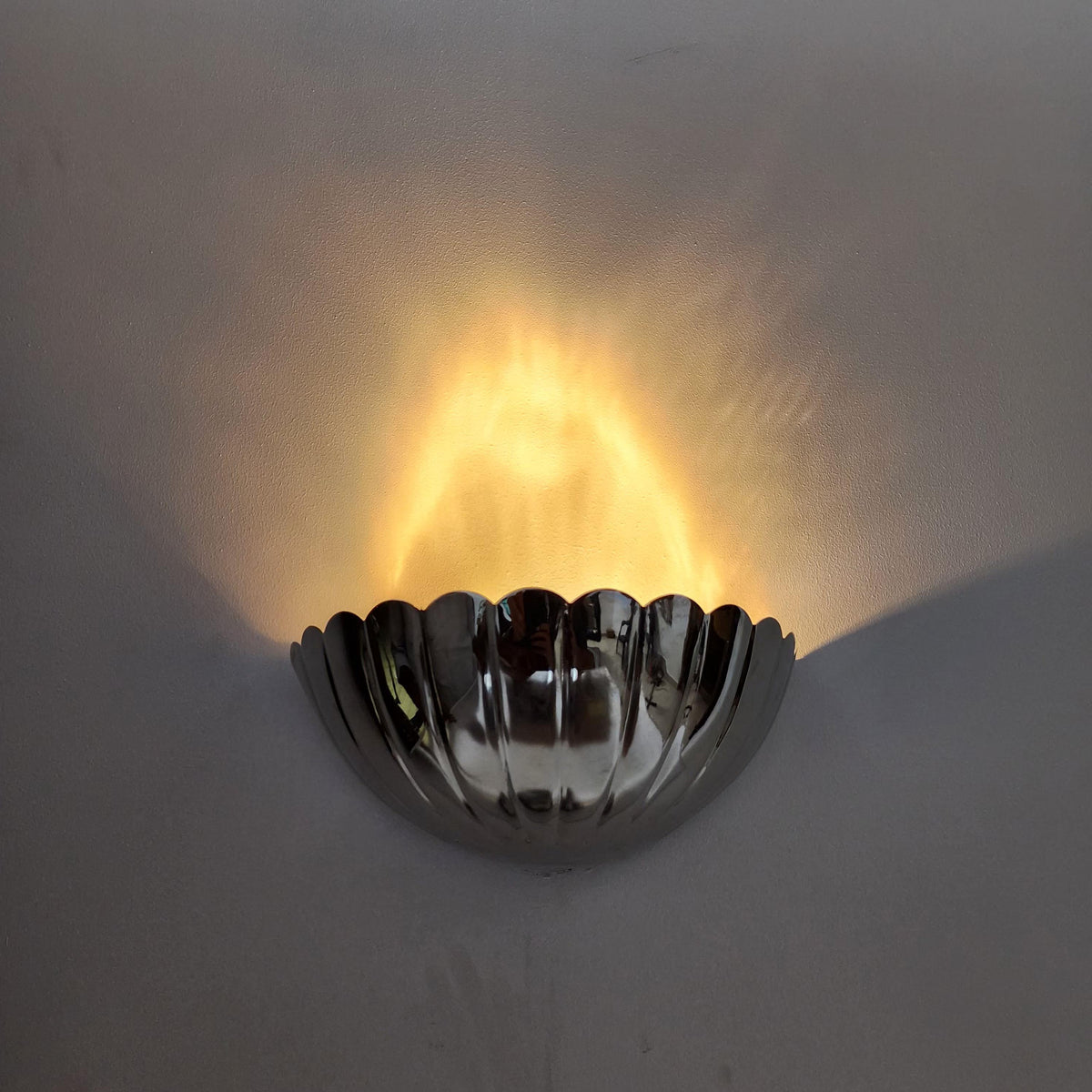 Modern Art Deco brass wall sconce with half-flower design — Ember Lighting