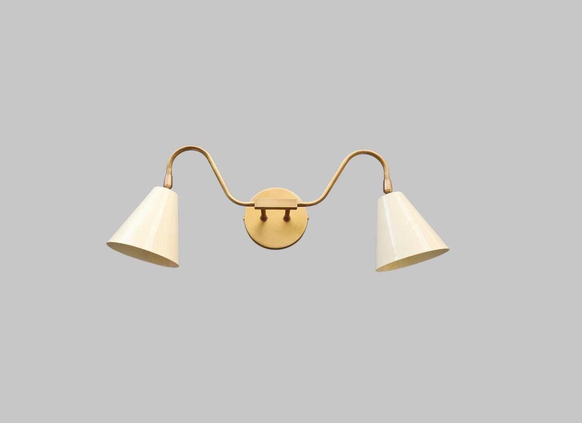 Modern double arm wall sconce in handcrafted brass. Ember Lighting