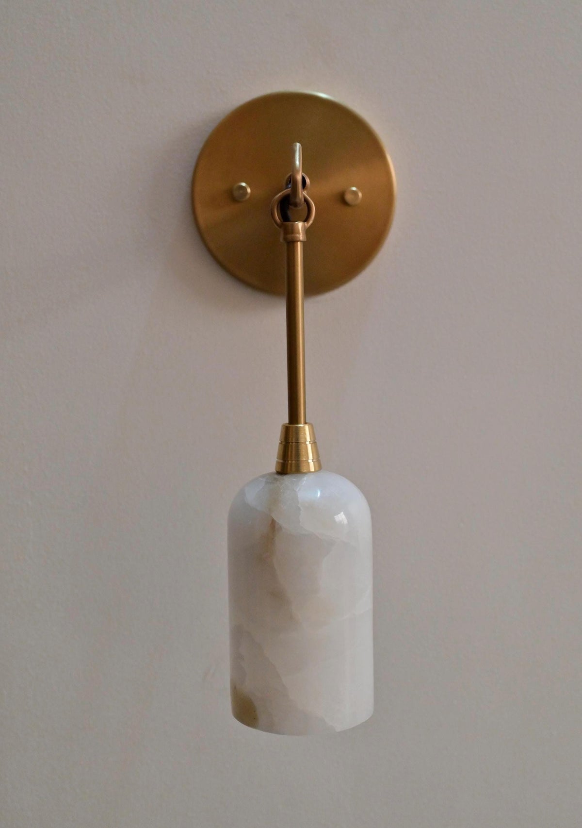 Natural stone and brass wall sconce for upscale interiors - Ember Lighting