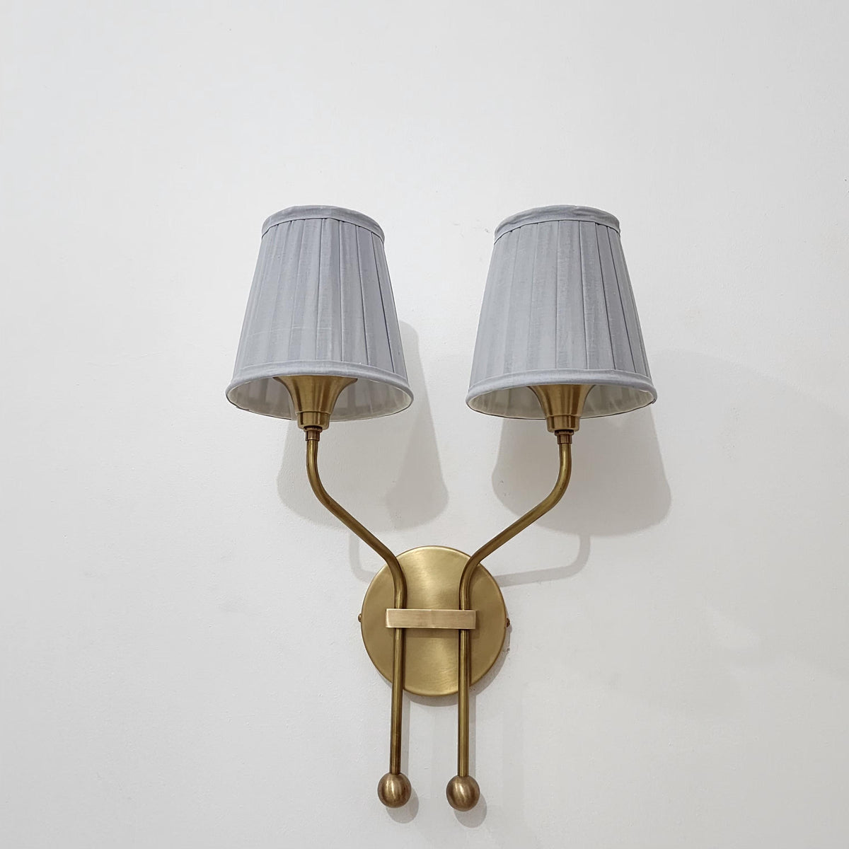 Stylish vintage brass wall sconce with double shades.
