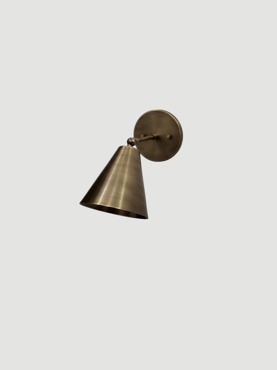 Vintage brass adjustable wall sconce with cone design.