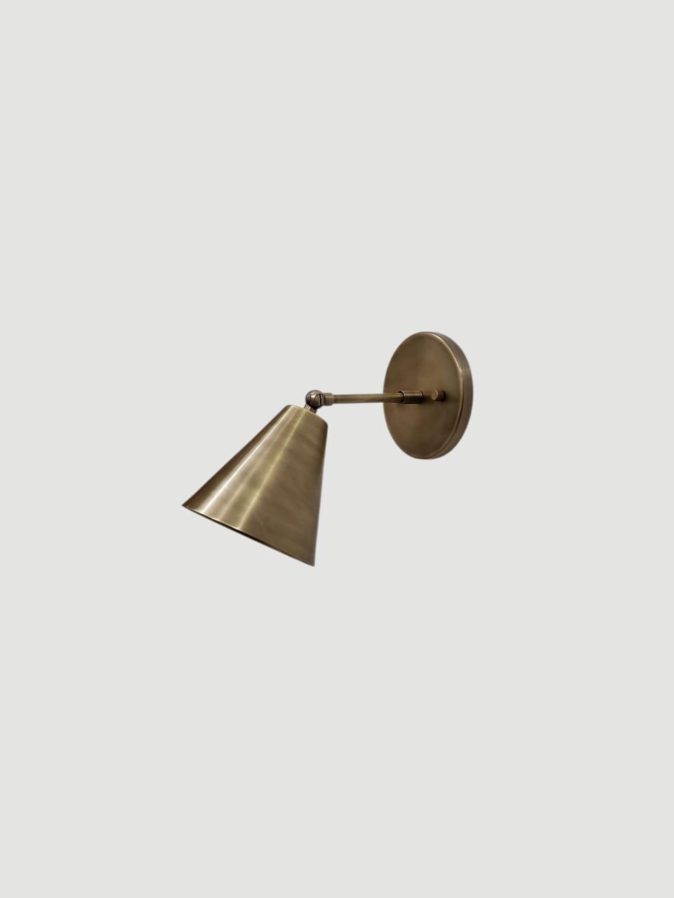 Vintage brass wall sconce with an adjustable cone lampshade.